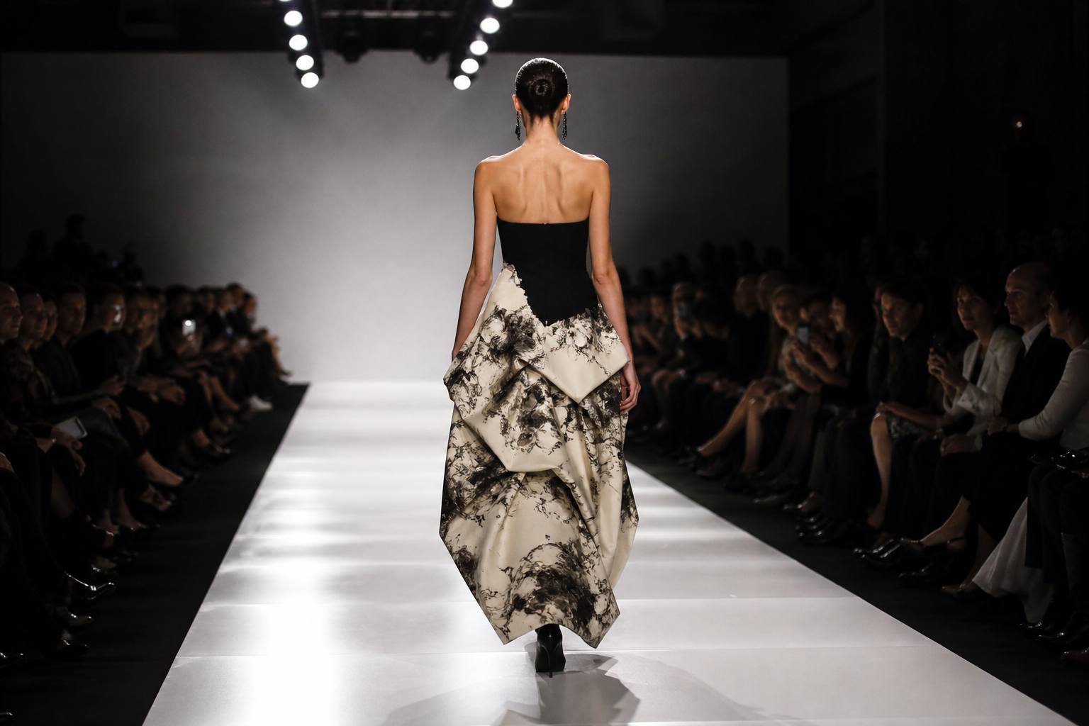 Fashion week runway show with dramatic lighting